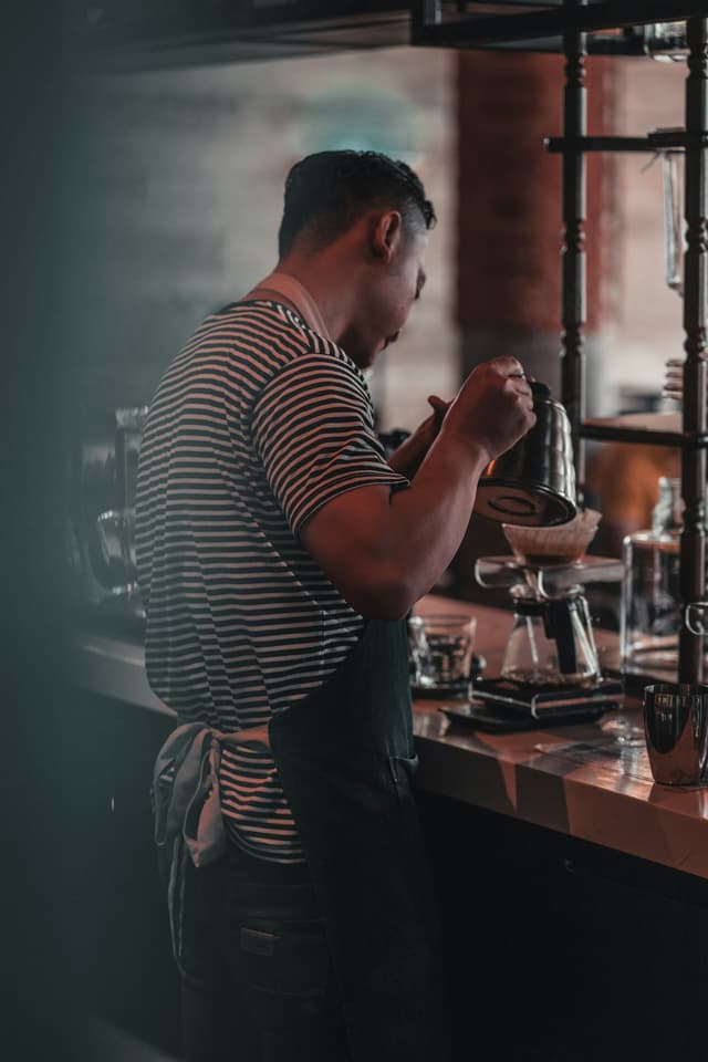 Barista pouring coffee into a carafe